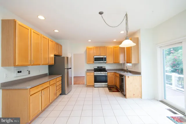 a kitchen with stainless steel appliances a refrigerator sink and cabinets