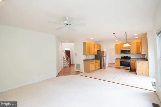 a view of a kitchen with a sink and cabinets