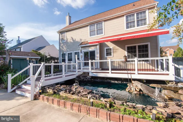 front view of a house with a wooden deck