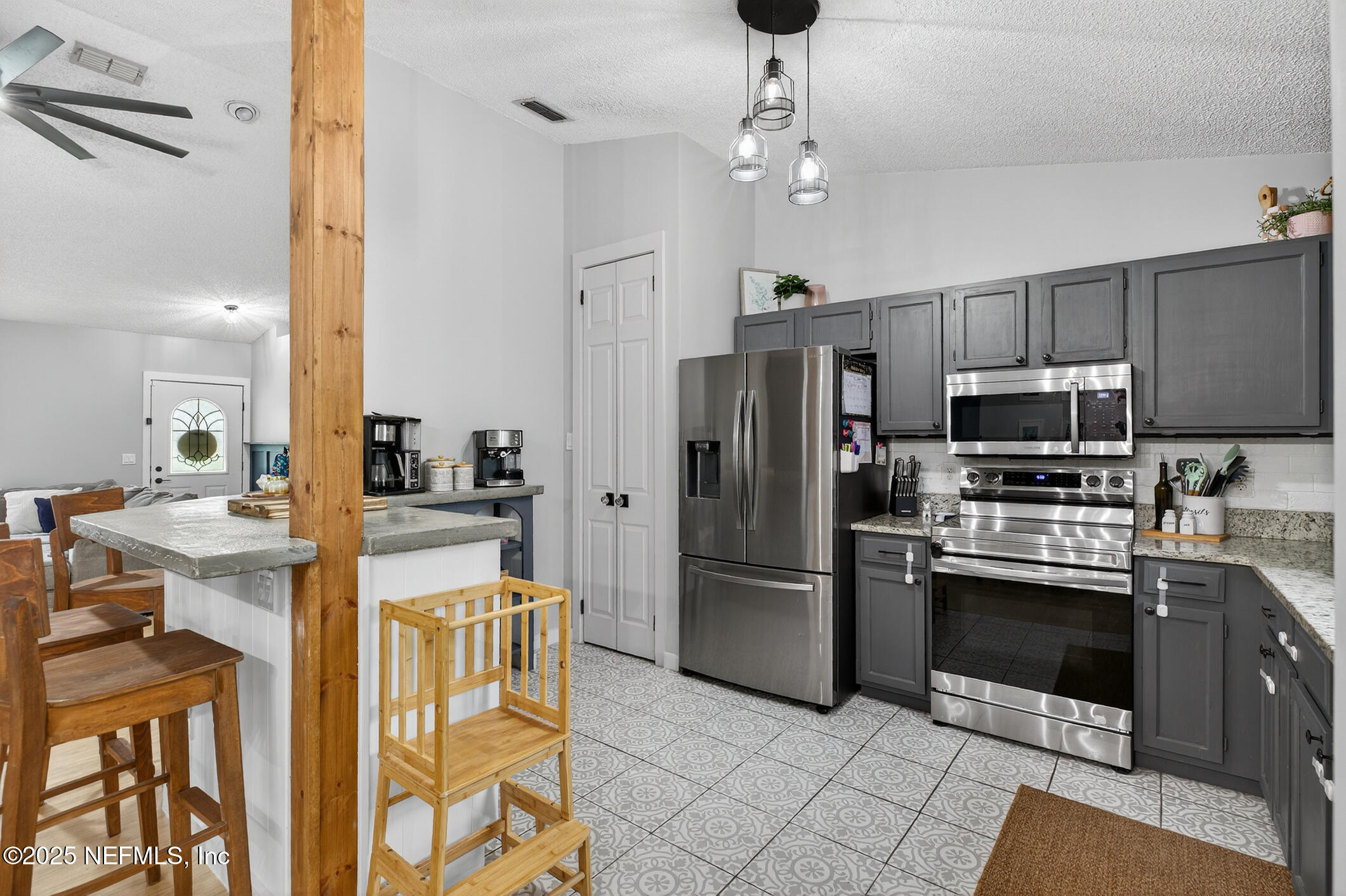 2172 Rothbury Drive Jacksonville, FL 32221 - Photo 12 of 28 a kitchen with stainless steel appliances granite countertop a refrigerator a stove top oven a sink and dishwasher