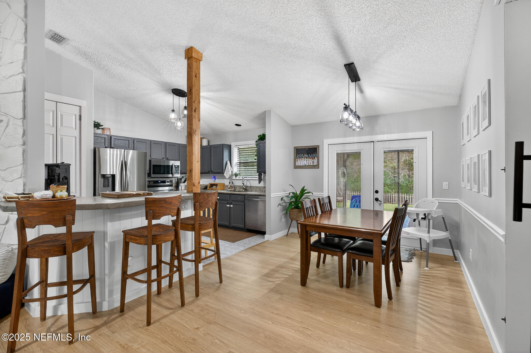 2172 Rothbury Drive Jacksonville, FL 32221 - Photo 19 of 28 a dining room with furniture a chandelier and wooden floor