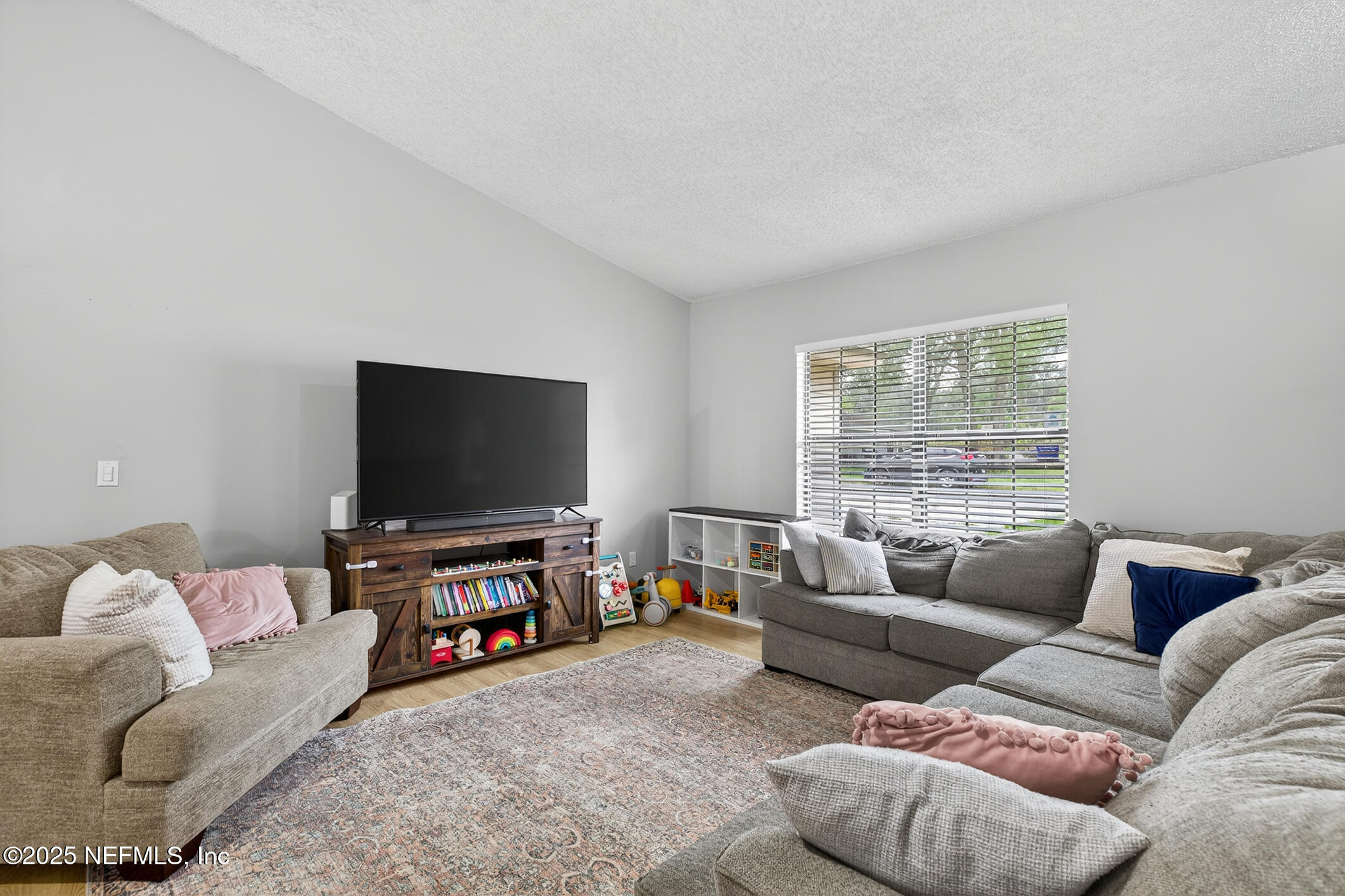 2172 Rothbury Drive Jacksonville, FL 32221 - Photo 9 of 28 a living room with furniture and a flat screen tv