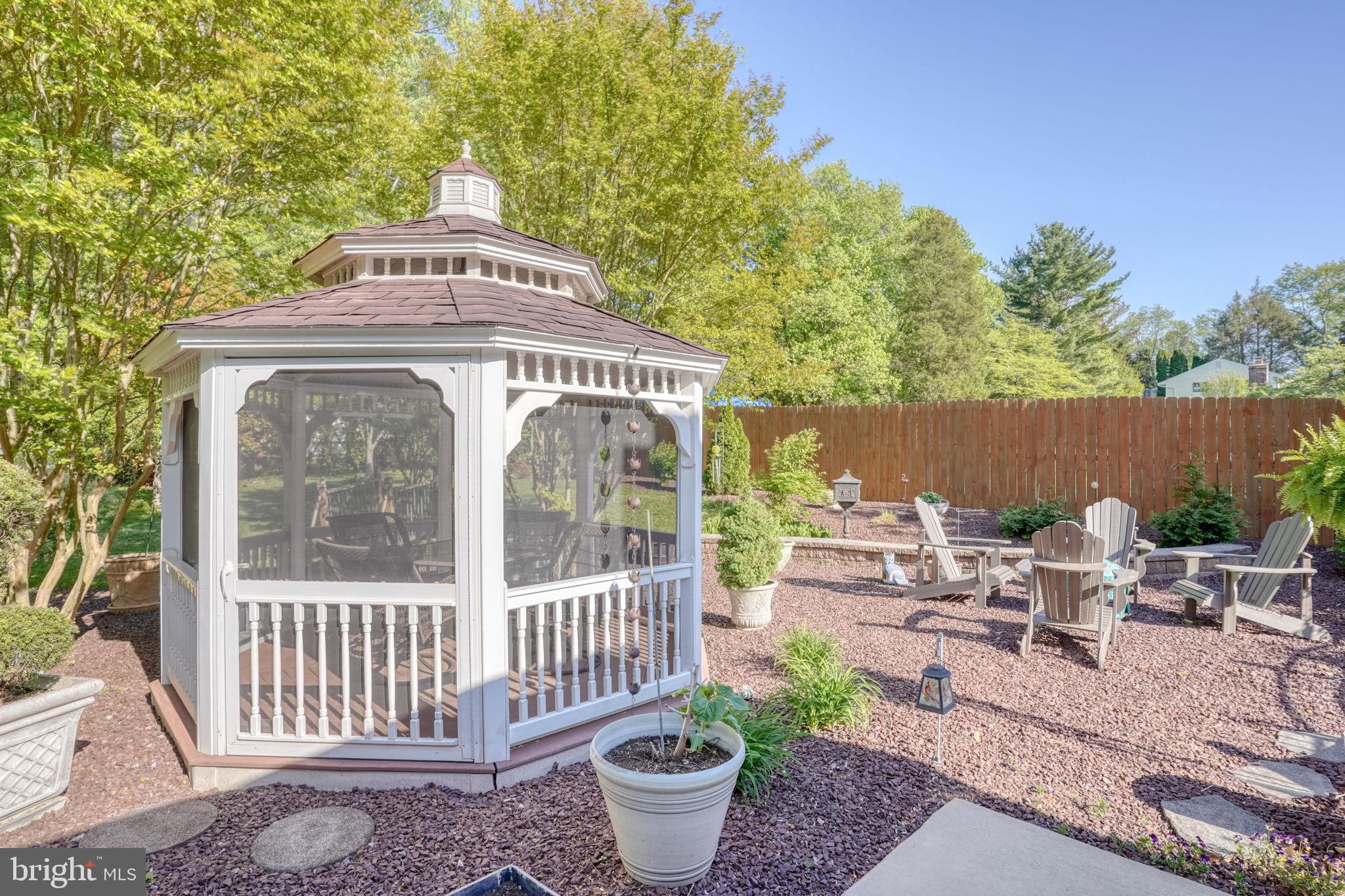 112 Tall Pines Road Newark, DE 19713 - Photo 20 of 62 a view of a patio with table and chairs and potted plants