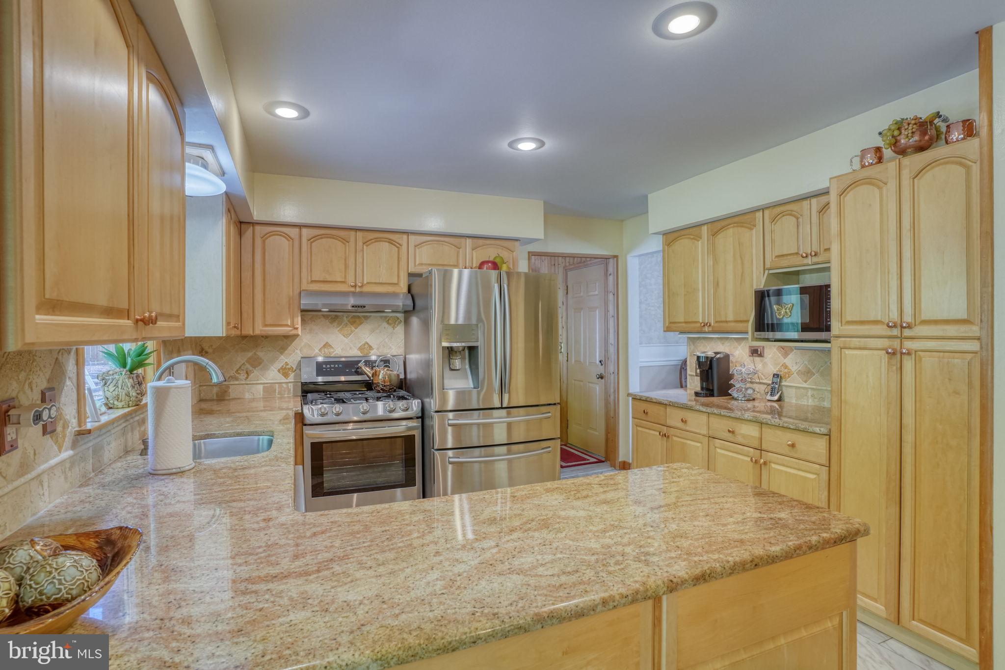 112 Tall Pines Road Newark, DE 19713 - Photo 44 of 62 a kitchen with granite countertop a refrigerator and a sink