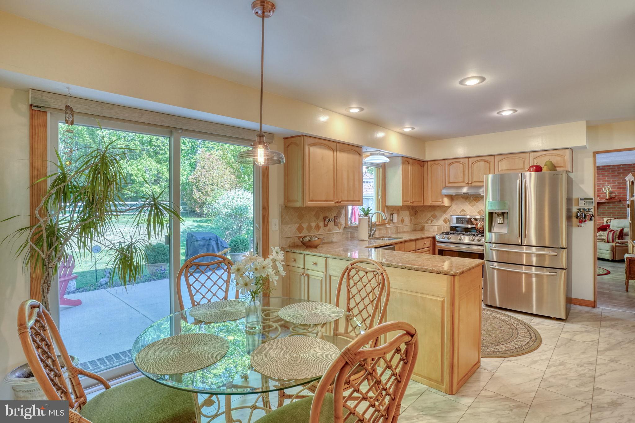 112 Tall Pines Road Newark, DE 19713 - Photo 46 of 62 a kitchen with stainless steel appliances granite countertop a stove a refrigerator a kitchen island a table and chairs