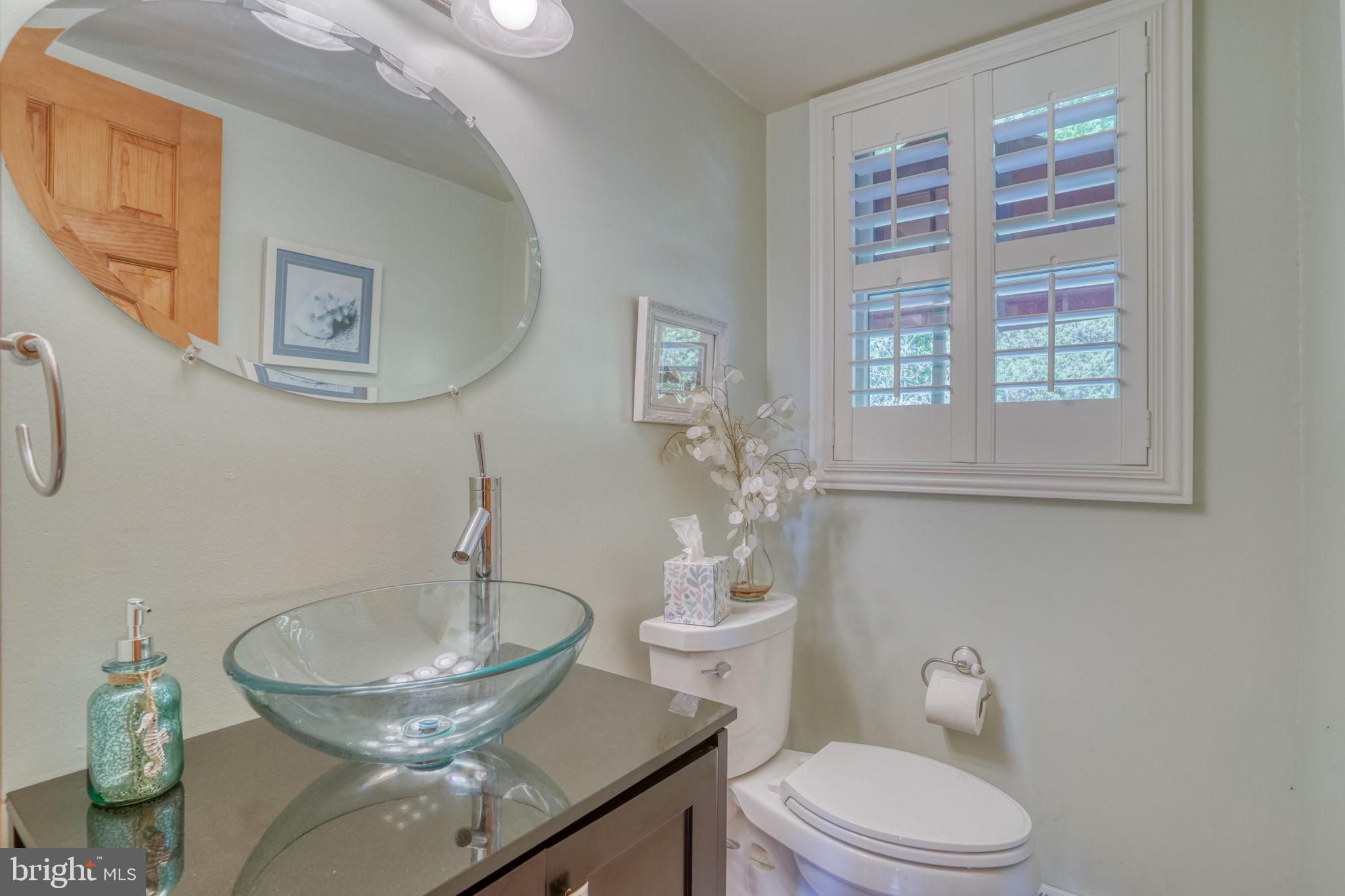 112 Tall Pines Road Newark, DE 19713 - Photo 47 of 62 a bathroom with a granite countertop toilet a sink and a mirror