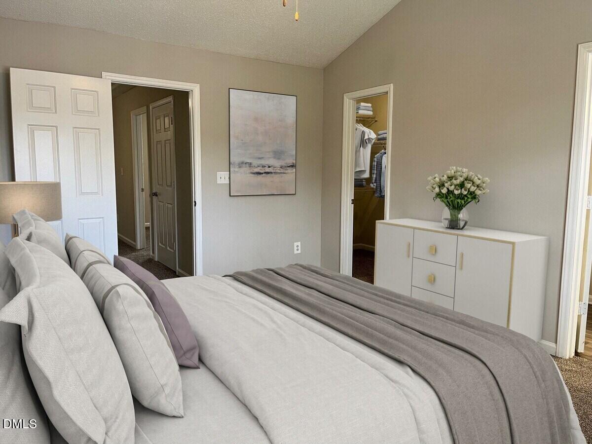 2101 Blackwolf Run Lane, Unit ST Raleigh, NC 27604 - Photo 11 of 30 a bedroom with a large bed and a potted plant