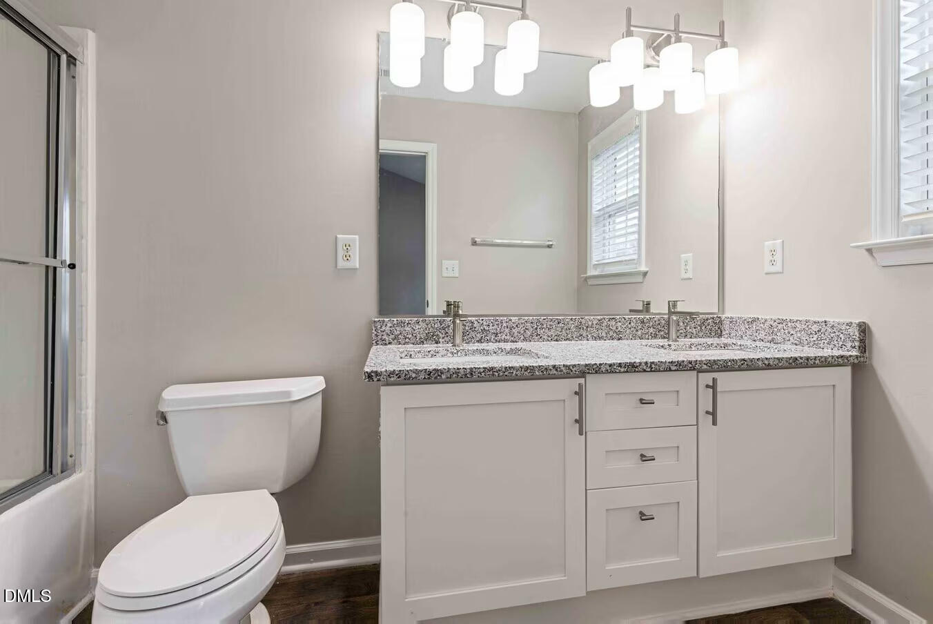 2101 Blackwolf Run Lane, Unit ST Raleigh, NC 27604 - Photo 12 of 30 a bathroom with a granite countertop toilet sink and a mirror