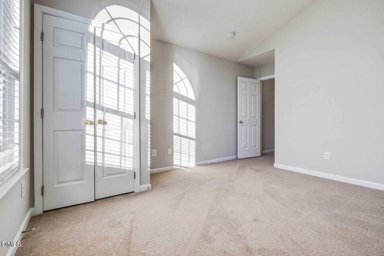 2101 Blackwolf Run Lane, Unit ST Raleigh, NC 27604 - Photo 23 of 30 an empty room with windows and chandelier