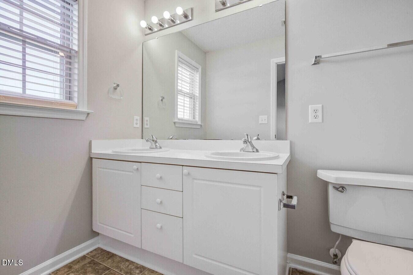 2101 Blackwolf Run Lane, Unit ST Raleigh, NC 27604 - Photo 26 of 30 a bathroom with a sink a toilet and a mirror
