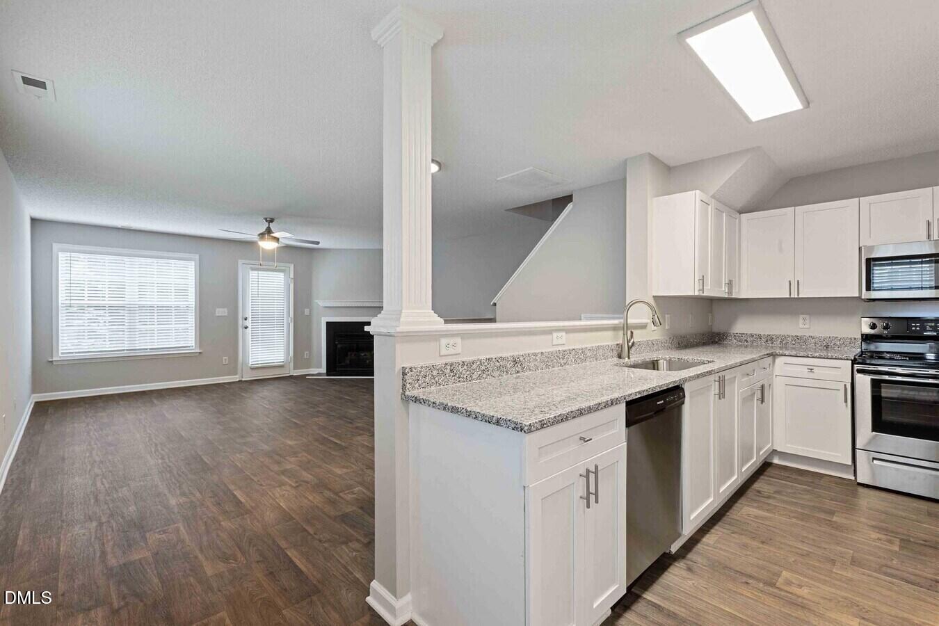 2101 Blackwolf Run Lane, Unit ST Raleigh, NC 27604 - Photo 27 of 30 a kitchen with a sink stove and cabinets