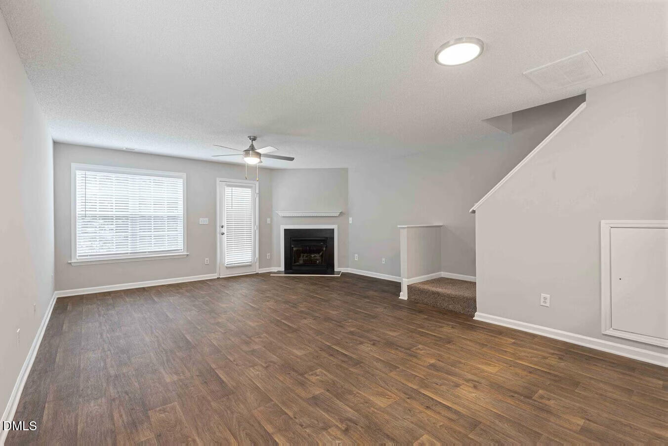 2101 Blackwolf Run Lane, Unit ST Raleigh, NC 27604 - Photo 5 of 30 an empty room with wooden floor fireplace and windows
