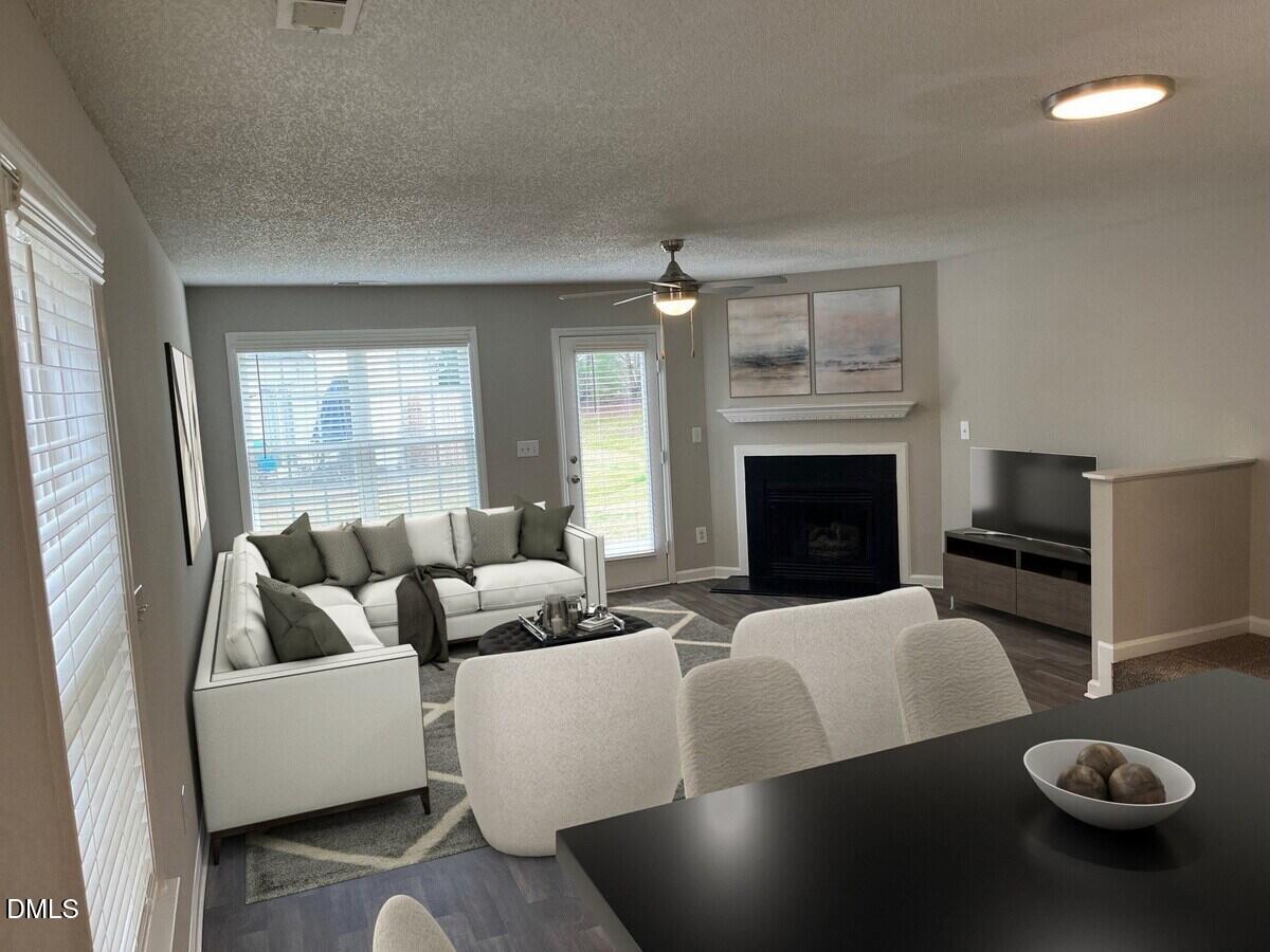 2101 Blackwolf Run Lane, Unit ST Raleigh, NC 27604 - Photo 6 of 30 a living room with furniture a fireplace and a large window