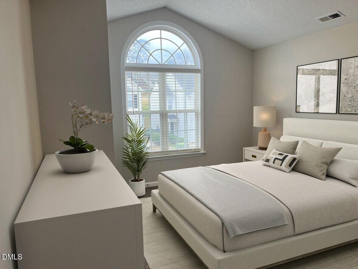 2101 Blackwolf Run Lane, Unit ST Raleigh, NC 27604 - Photo 8 of 30 a bedroom with a bed and a potted plant