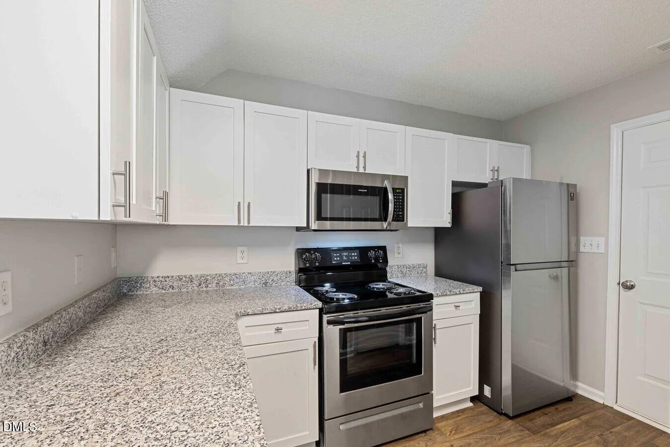 2101 Blackwolf Run Lane, Unit ST Raleigh, NC 27604 - Photo 9 of 30 a kitchen with white cabinets and stainless steel appliances