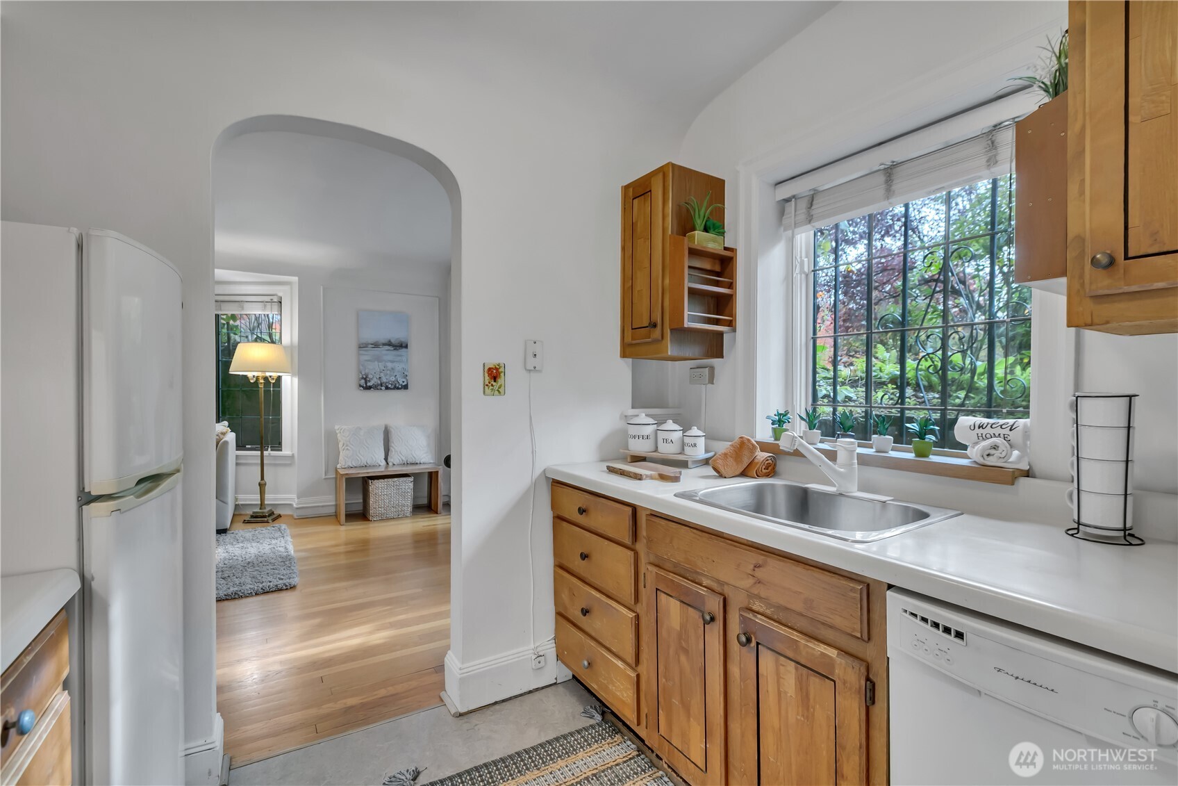 1101 17th Avenue, Unit 101 Seattle, WA 98122 - Photo 16 of 25 a kitchen with stainless steel appliances granite countertop a sink stove and cabinets