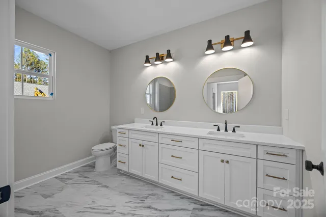 a bathroom with 2 sink and a mirror