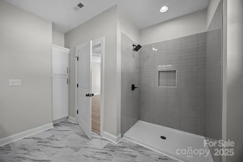 a bathroom with a bathtub and shower