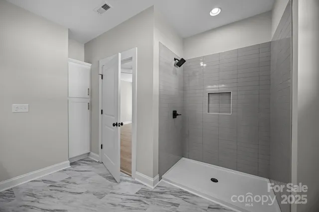 a bathroom with a bathtub and shower