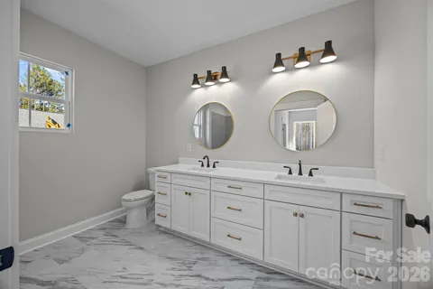 a bathroom with 2 sink and a mirror