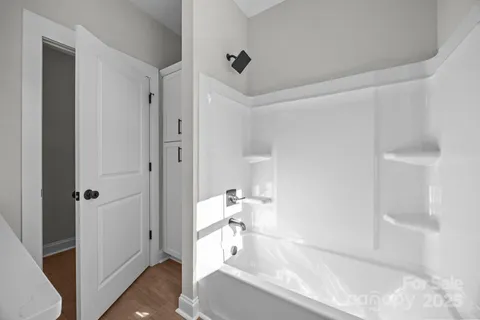 a bathroom with a bathtub and a shower