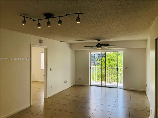 a view of a livingroom with a ceiling fan and window