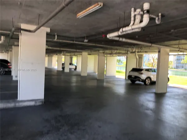 a view of a car garage with a car parked