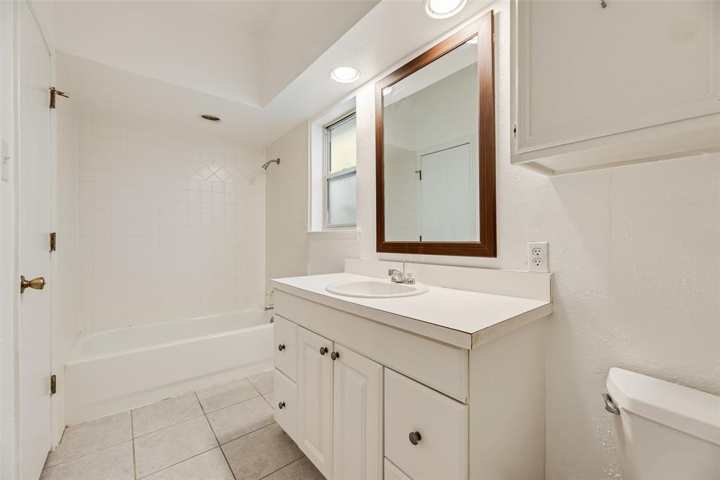 4988 Thunder Road Dallas, TX 75244 - Photo 26 of 32 Bathroom featuring a white vanity with integrated sink, a rectangular framed mirror, an overhead recessed light, and a window for natural light