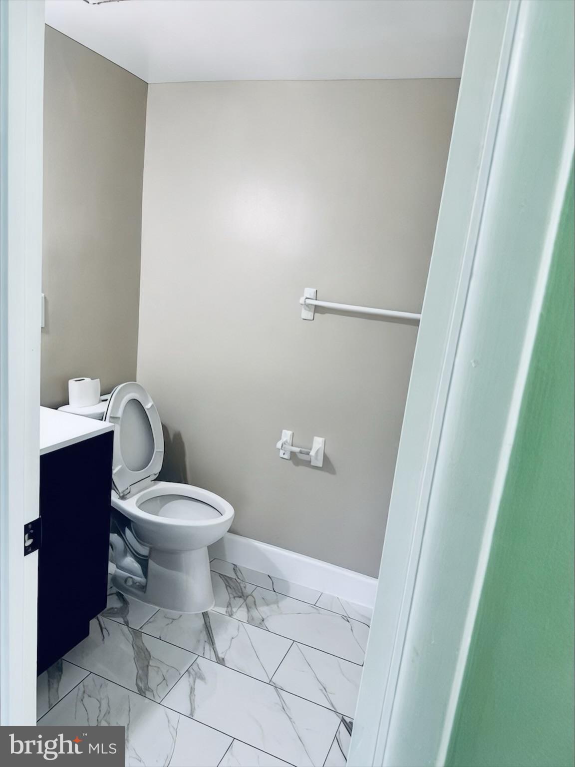 15712 Dorset Road, Unit 198 Laurel, MD 20707 - Photo 20 of 35 a white toilet sitting next to a white sink and vanity