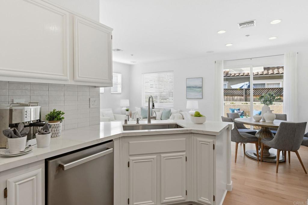 6180 Citracado Circle Carlsbad, CA 92009 - Photo 11 of 42 a kitchen with white cabinets sink and window