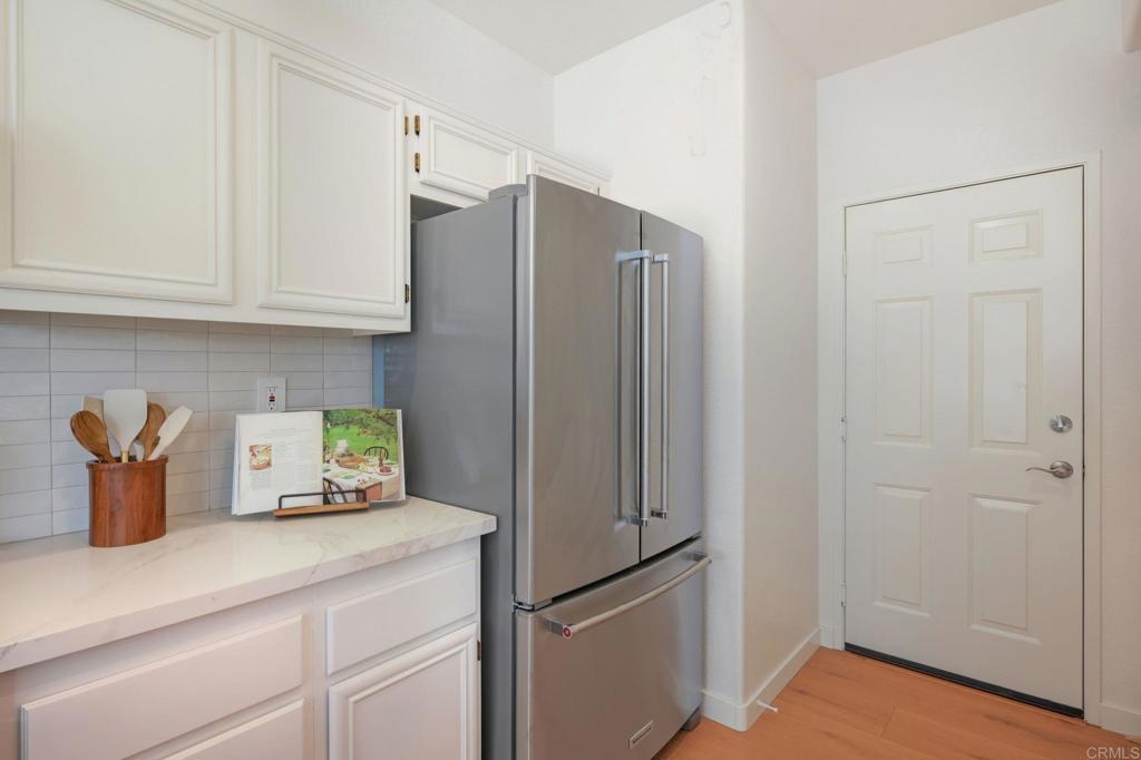 6180 Citracado Circle Carlsbad, CA 92009 - Photo 12 of 42 a kitchen with stainless steel appliances a refrigerator and cabinets