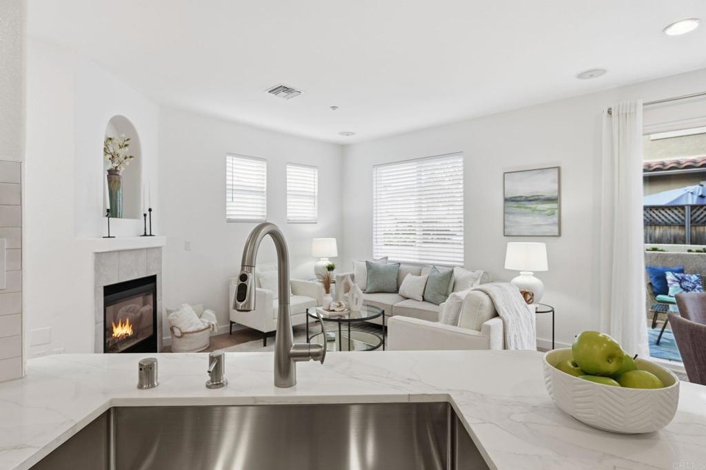 6180 Citracado Circle Carlsbad, CA 92009 - Photo 14 of 42 a living room with furniture and a fireplace