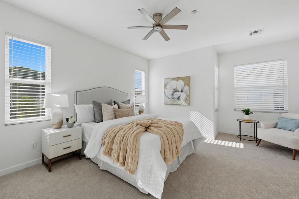 6180 Citracado Circle Carlsbad, CA 92009 - Photo 16 of 42 a bedroom with a bed a couch and a chandelier