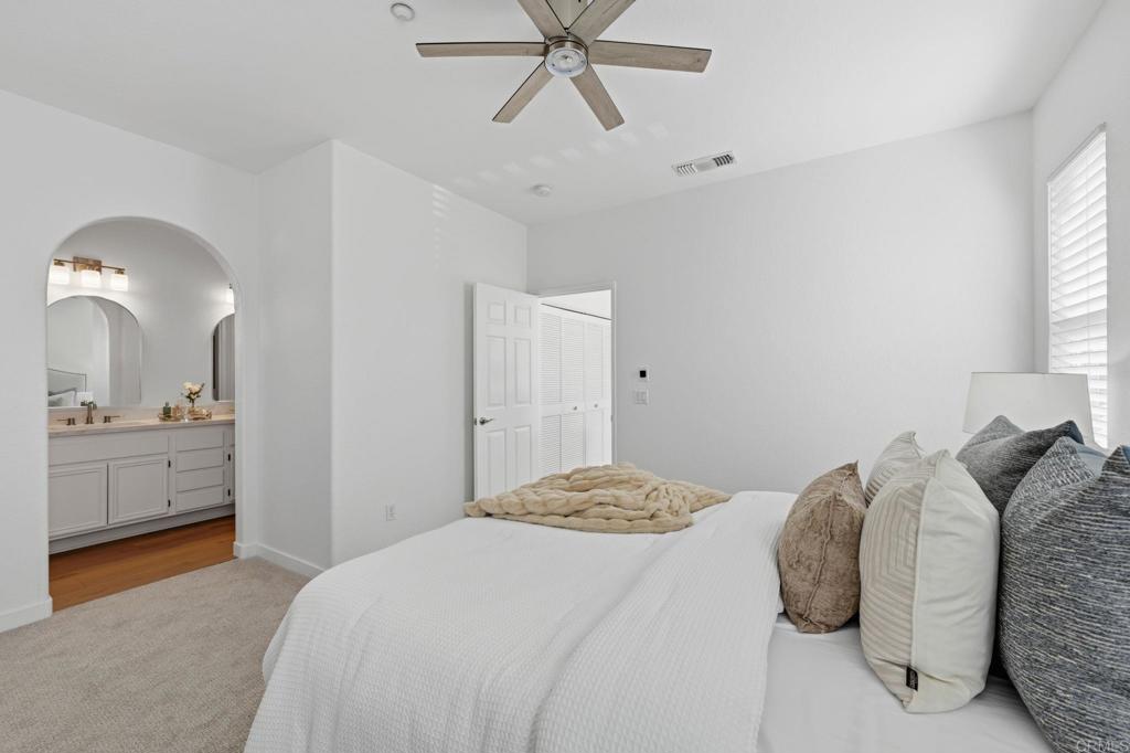 6180 Citracado Circle Carlsbad, CA 92009 - Photo 20 of 42 a bedroom with a bed and window