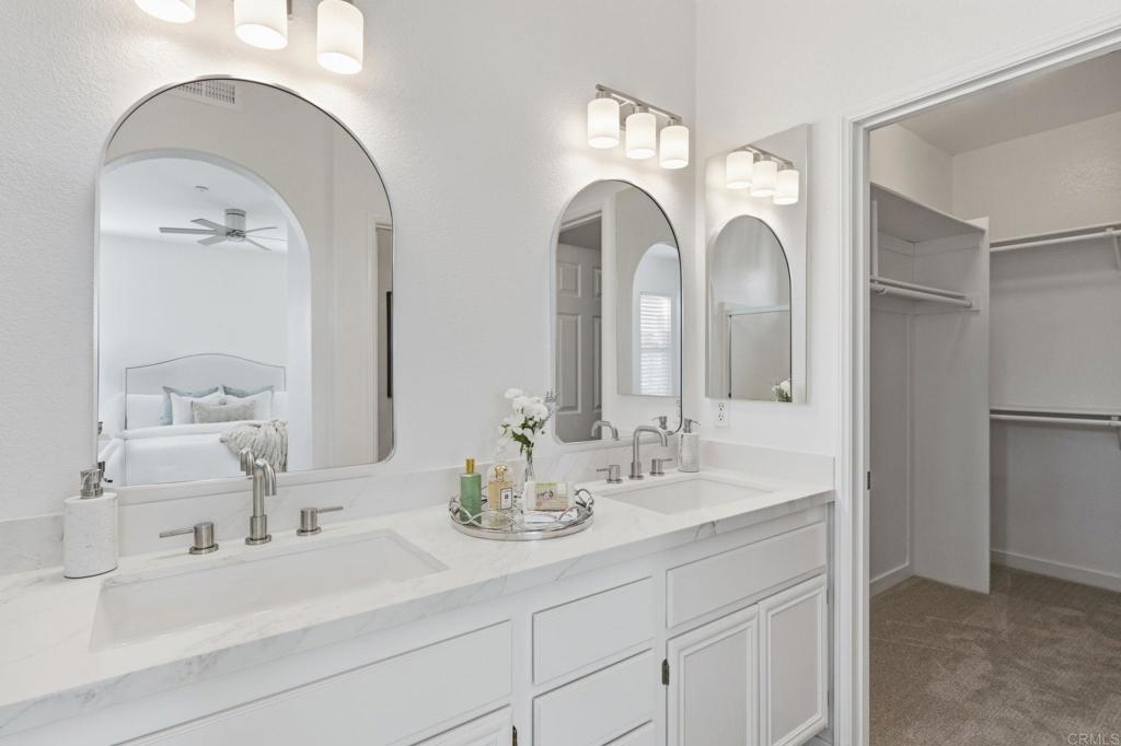 6180 Citracado Circle Carlsbad, CA 92009 - Photo 21 of 42 a bathroom with double vanity sinks and a mirror