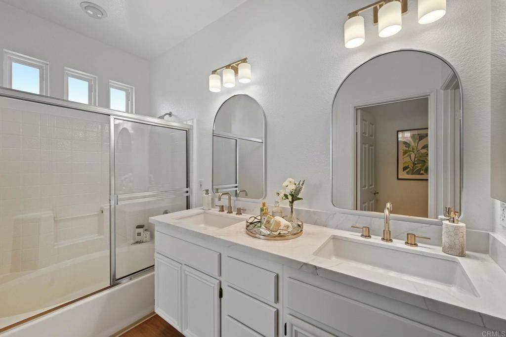 6180 Citracado Circle Carlsbad, CA 92009 - Photo 22 of 42 a bathroom with double vanity sinks and a mirror