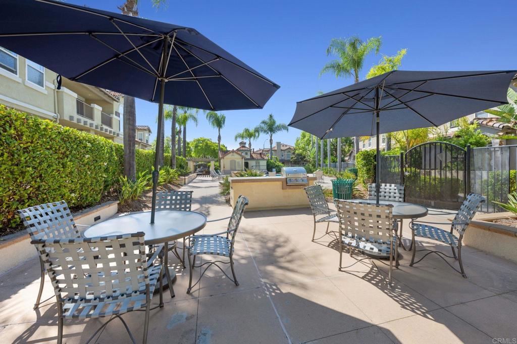 6180 Citracado Circle Carlsbad, CA 92009 - Photo 35 of 42 a view of patio with chairs and table under an umbrella