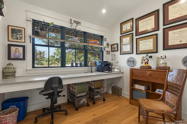 a view of a workspace with furniture and a window