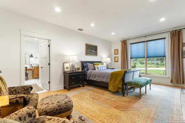 a bedroom with a bed and glass windows