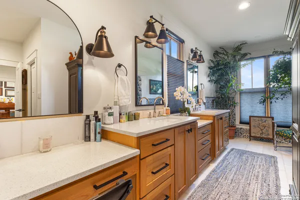 a bathroom with a sink double vanity granite and a mirror