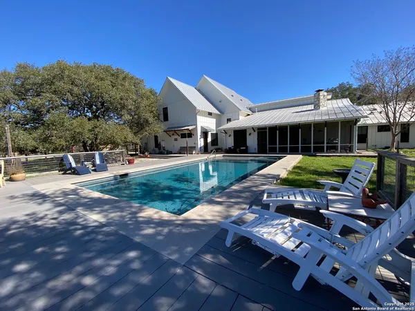 a view of a patio with table and chairs a barbeque with wooden fence