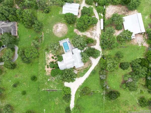 an aerial view of a house with a yard