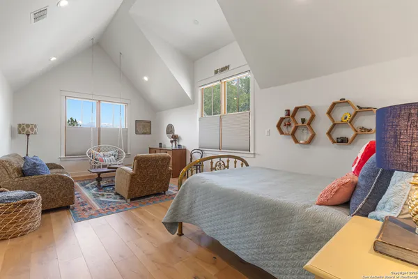 a bedroom with furniture and wooden floor