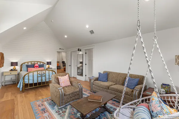 a living room with furniture and a wooden floor