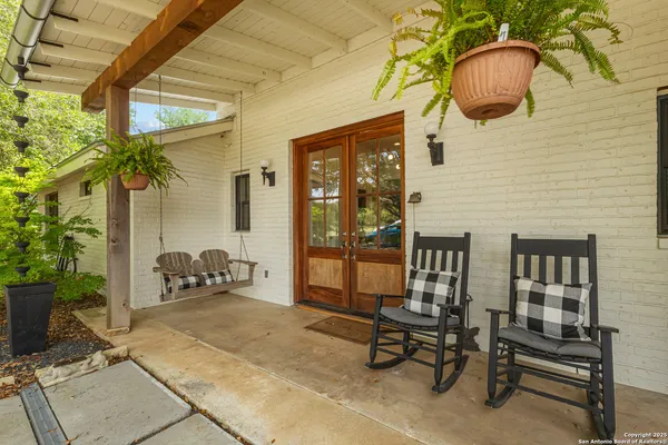 a backyard of a house with table and chairs