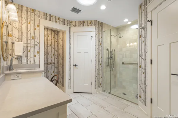 a bathroom with a shower and a mirror