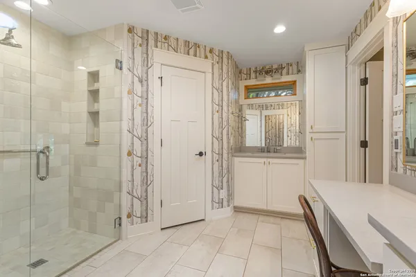a living room with patio furniture and garden view