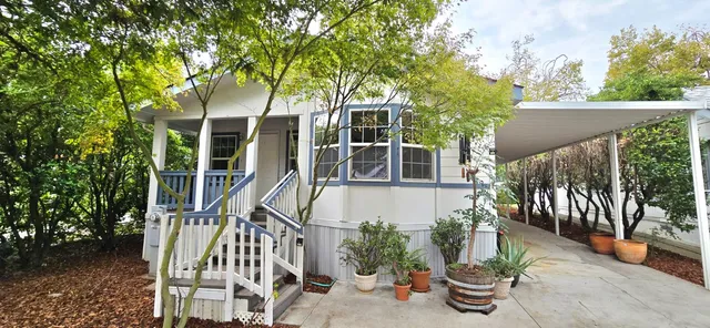 a view of a house with backyard and sitting area