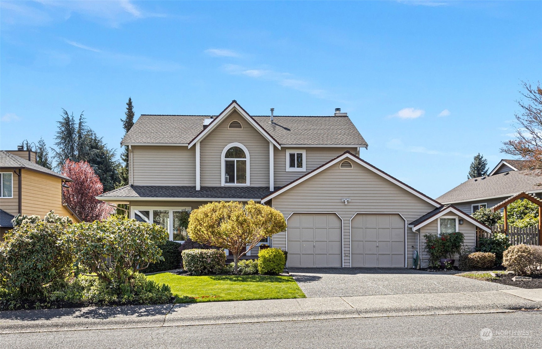 a front view of a house with a garden