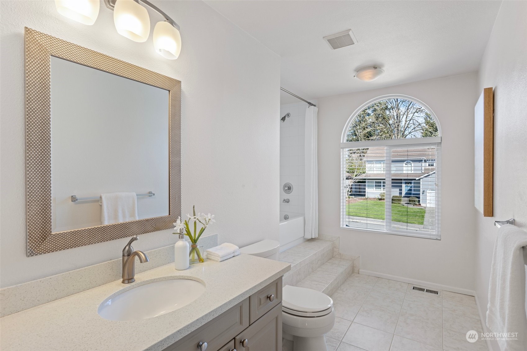 112 236th Place Southwest Bothell, WA 98021 - Photo 23 of 40 a bathroom with a granite countertop toilet a sink and a large mirror
